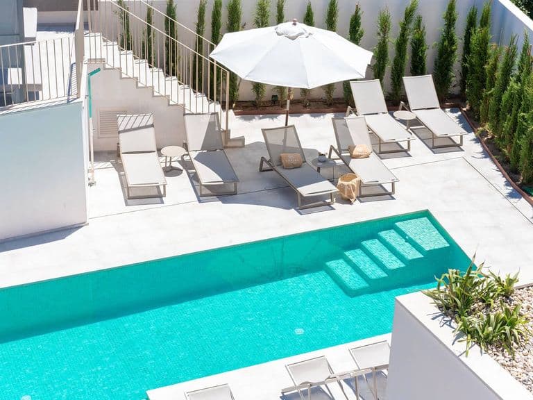 Pool des Ynaira Hotels in Ariany mit Liegen und Sonnenschirm